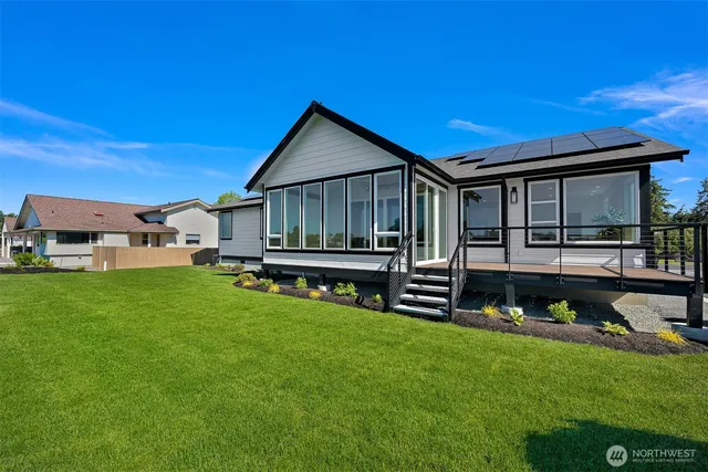 a backyard of a house with table and chairs