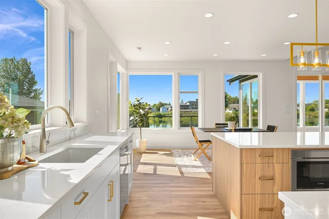 a large kitchen with stainless steel appliances a large window and a sink