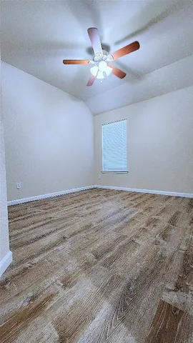 a view of room with fan and wooden floor