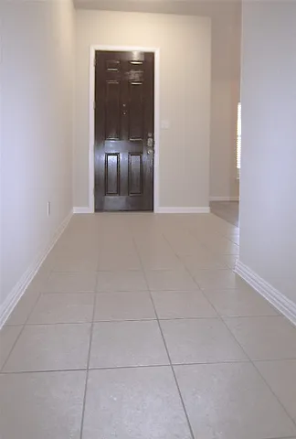 a view of a room with wooden floor and chandelier