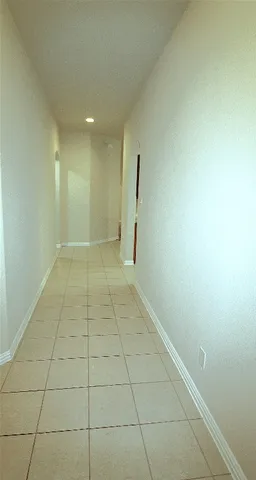 a view of a livingroom with an empty space and a window