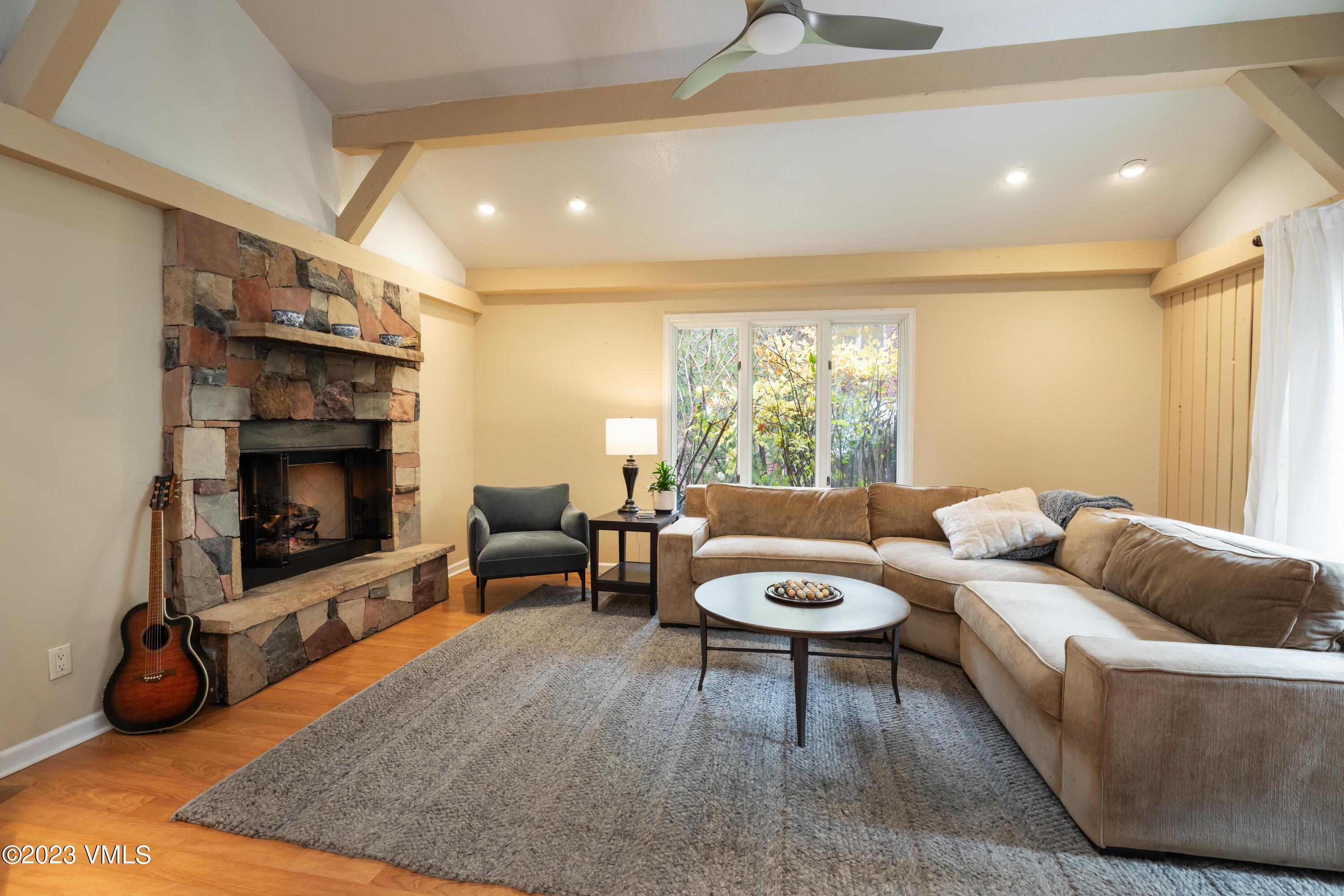 a living room with furniture a window and a fireplace
