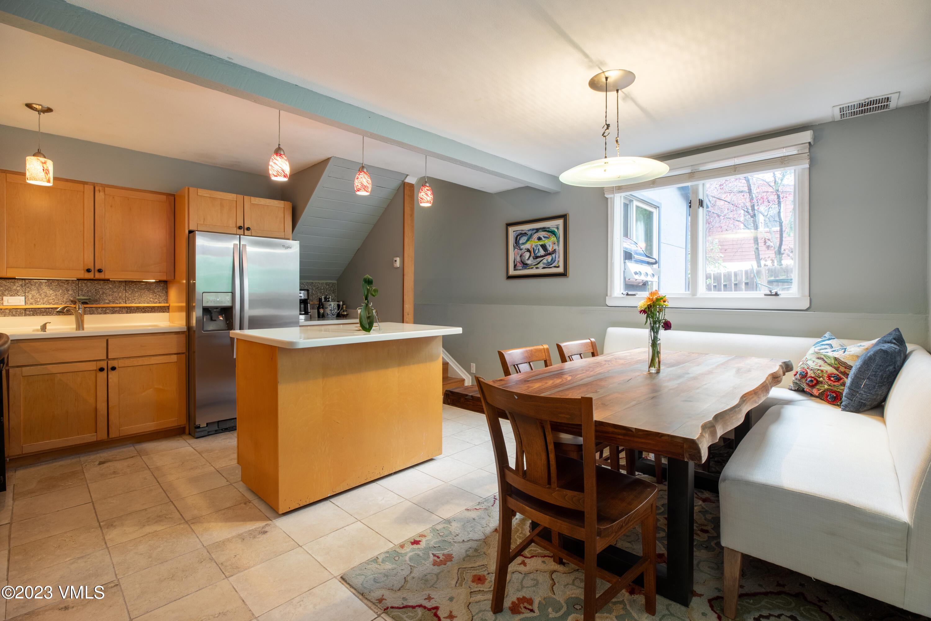 1176 Deer Boulevard, Unit A Avon, CO 81620 - Photo 3 of 8 a view of a dining room with furniture and a chandelier