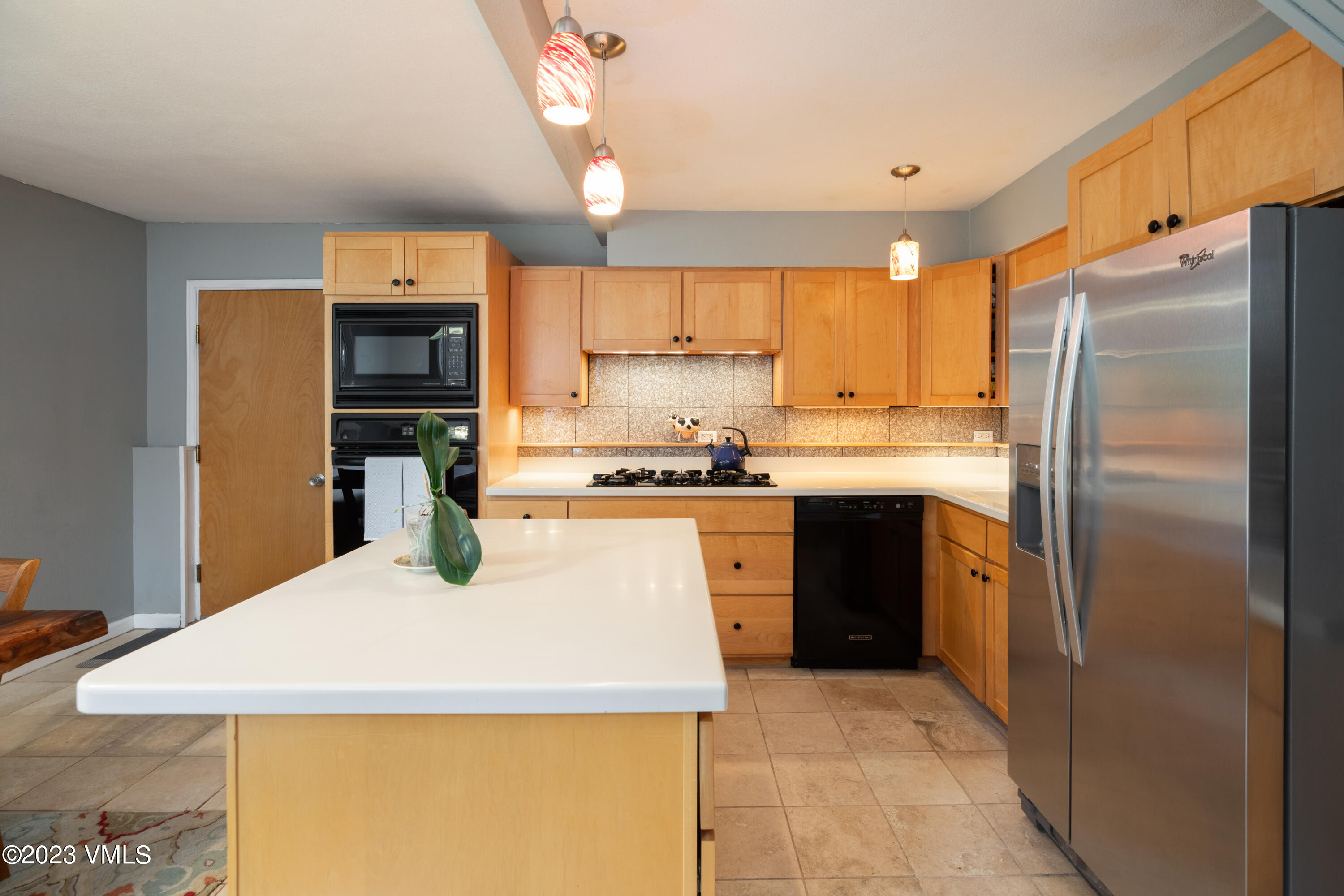 1176 Deer Boulevard, Unit A Avon, CO 81620 - Photo 4 of 8 a kitchen with stainless steel appliances a refrigerator sink and cabinets
