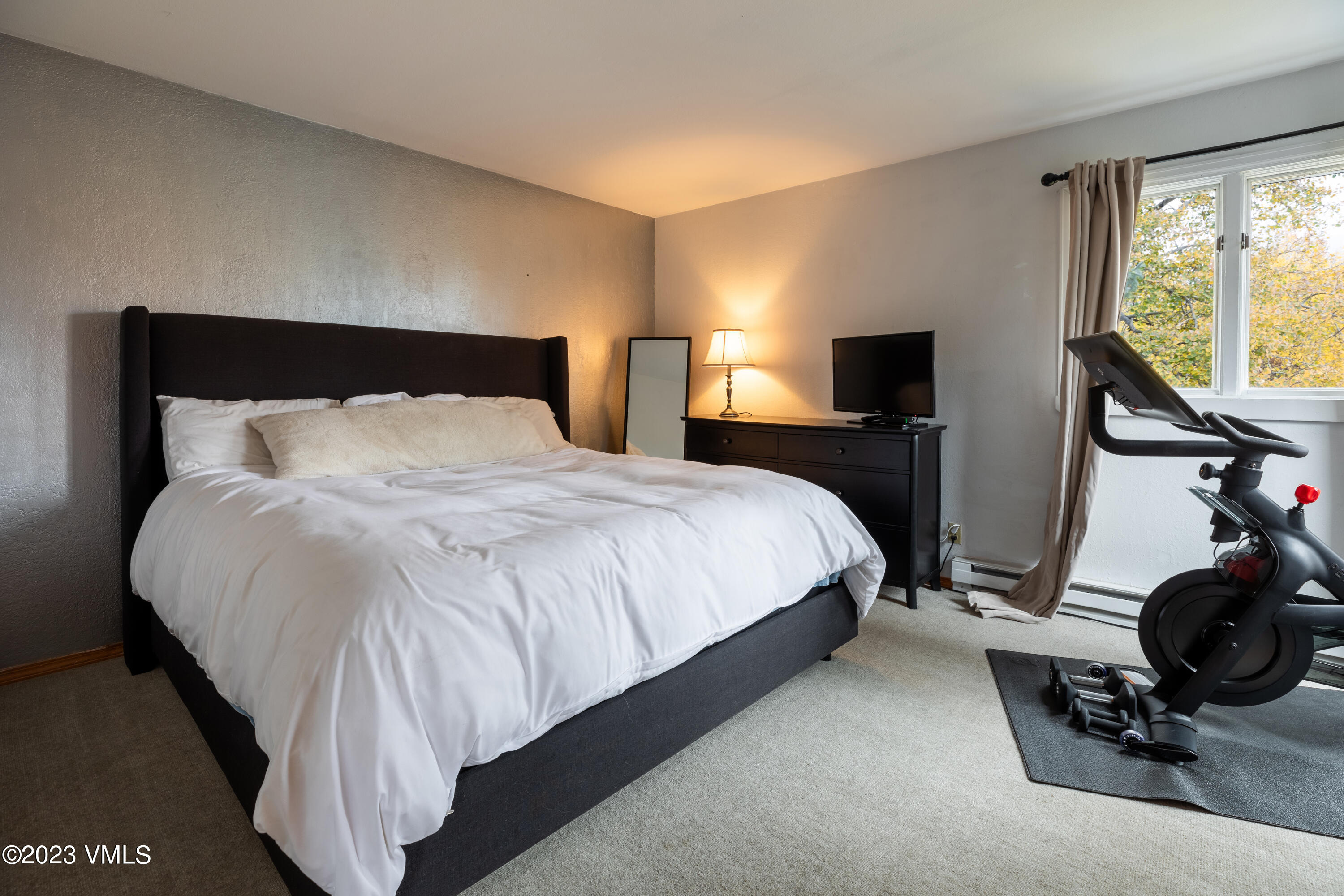 1176 Deer Boulevard, Unit A Avon, CO 81620 - Photo 6 of 8 a bedroom with a bed and wooden floor