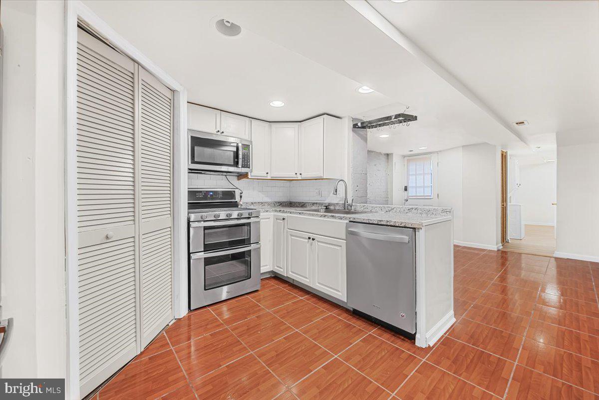 30 R Street Northeast, Unit B Washington, DC 20002 - Photo 13 of 21 a kitchen with stainless steel appliances granite countertop a refrigerator and a stove top oven