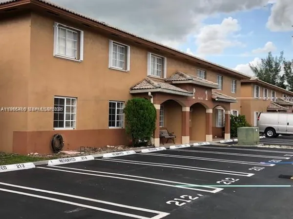 a view of a building with car parked