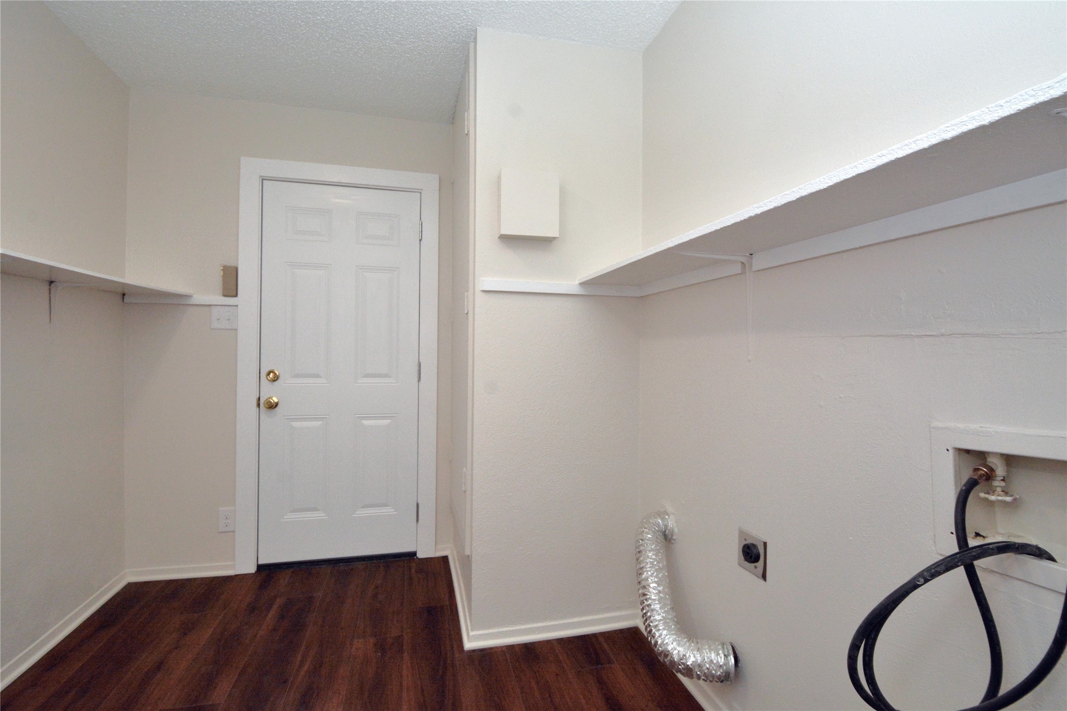 11314 Walnut Ridge Drive, Unit B Austin, TX 78753 - Photo 10 of 19 Functional laundry room offers ample shelving and rich wood flooring.