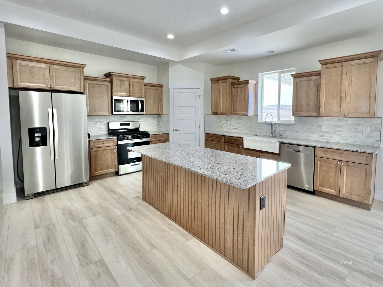142 Diamond Rdg Drive Spring Creek, NV 89815 - Photo 2 of 36 a kitchen with stainless steel appliances granite countertop a stove top oven a refrigerator a sink and dishwasher with wooden floor
