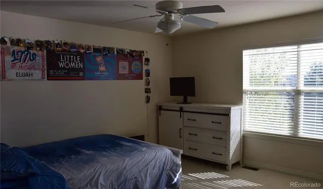 a bedroom with a bed and a window