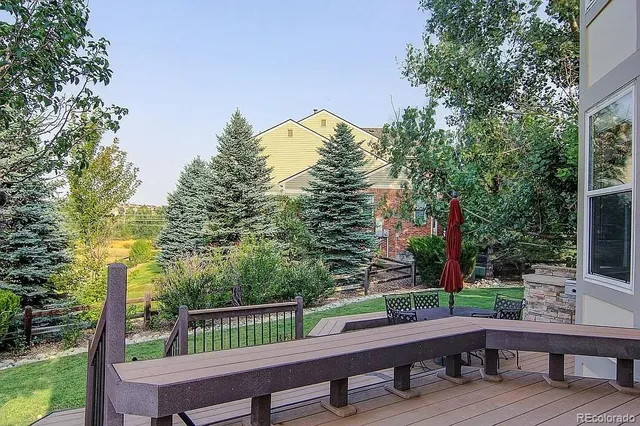 a view of backyard with deck and outdoor seating