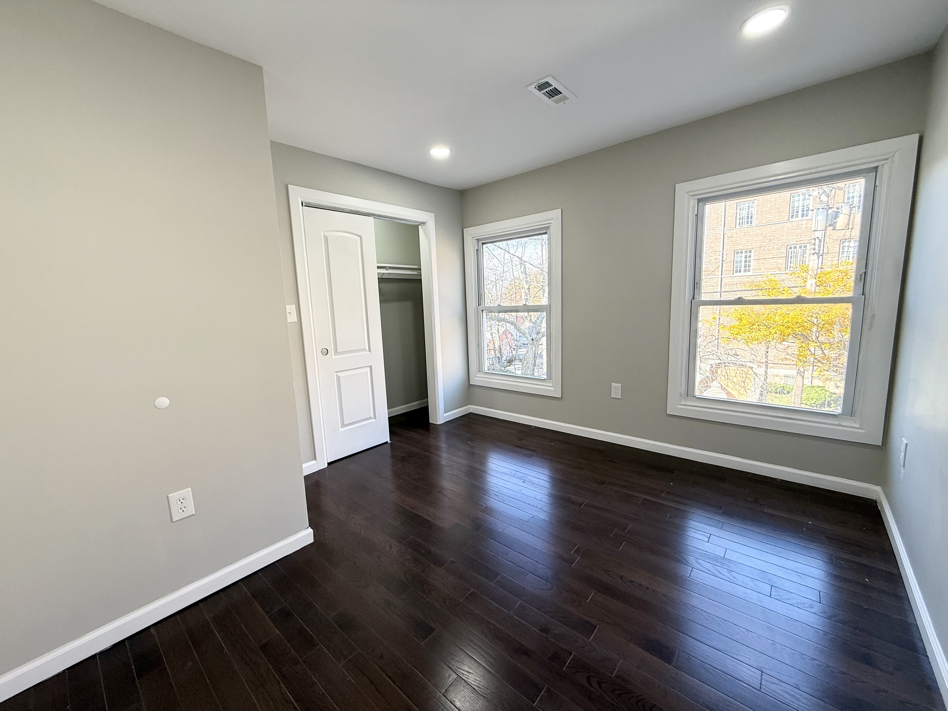 41 Howe Street, Unit 2 New Haven, CT 06511 - Photo 3 of 9 an empty room with wooden floor and windows