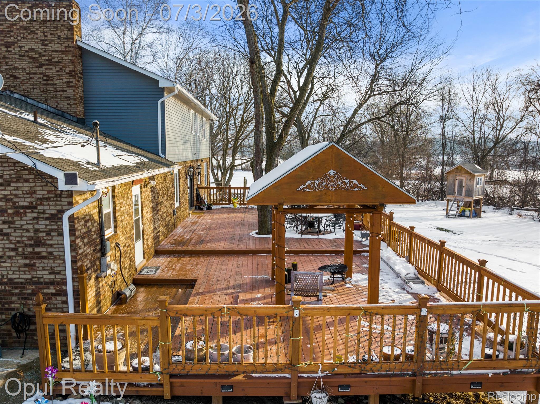 8855 Gross Road Dexter, MI 48130 - Photo 5 of 53 Multi-level wood deck featuring a covered gazebo, wood railings, and a secondary structure