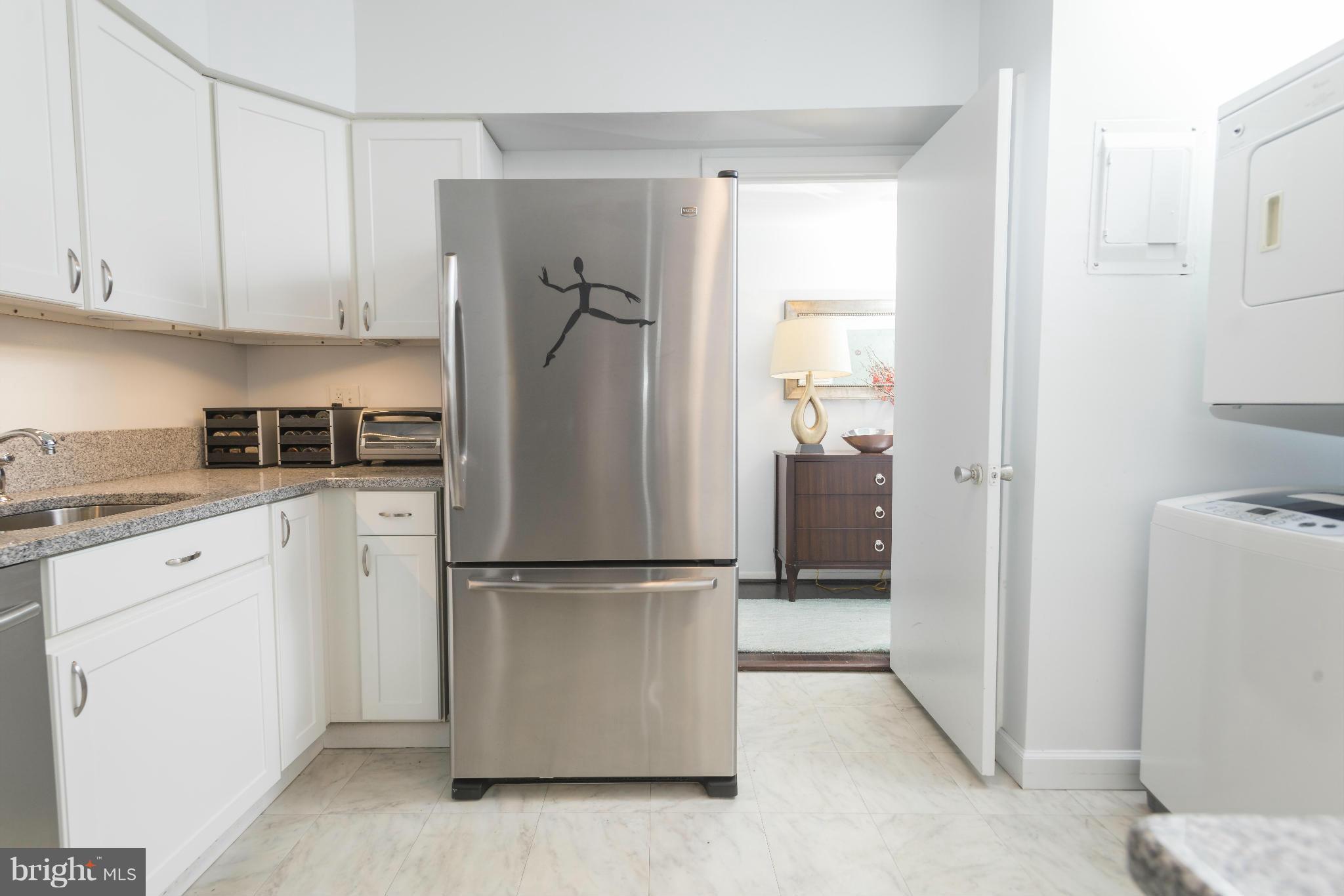 5 Hamill Road, Unit 5C Baltimore, MD 21210 - Photo 12 of 24 a kitchen with a refrigerator and cabinets