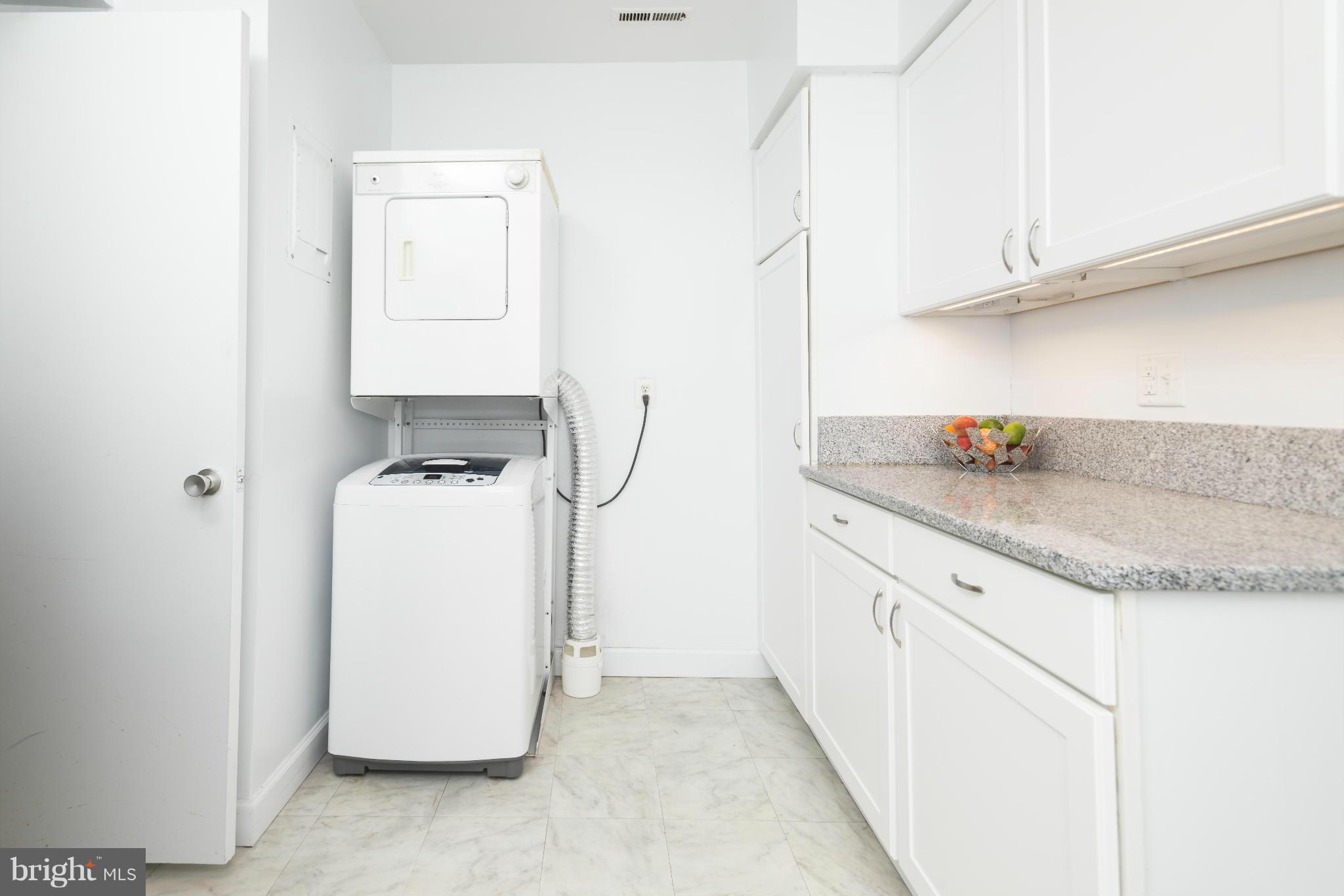5 Hamill Road, Unit 5C Baltimore, MD 21210 - Photo 13 of 24 a utility room with cabinets washer and dryer
