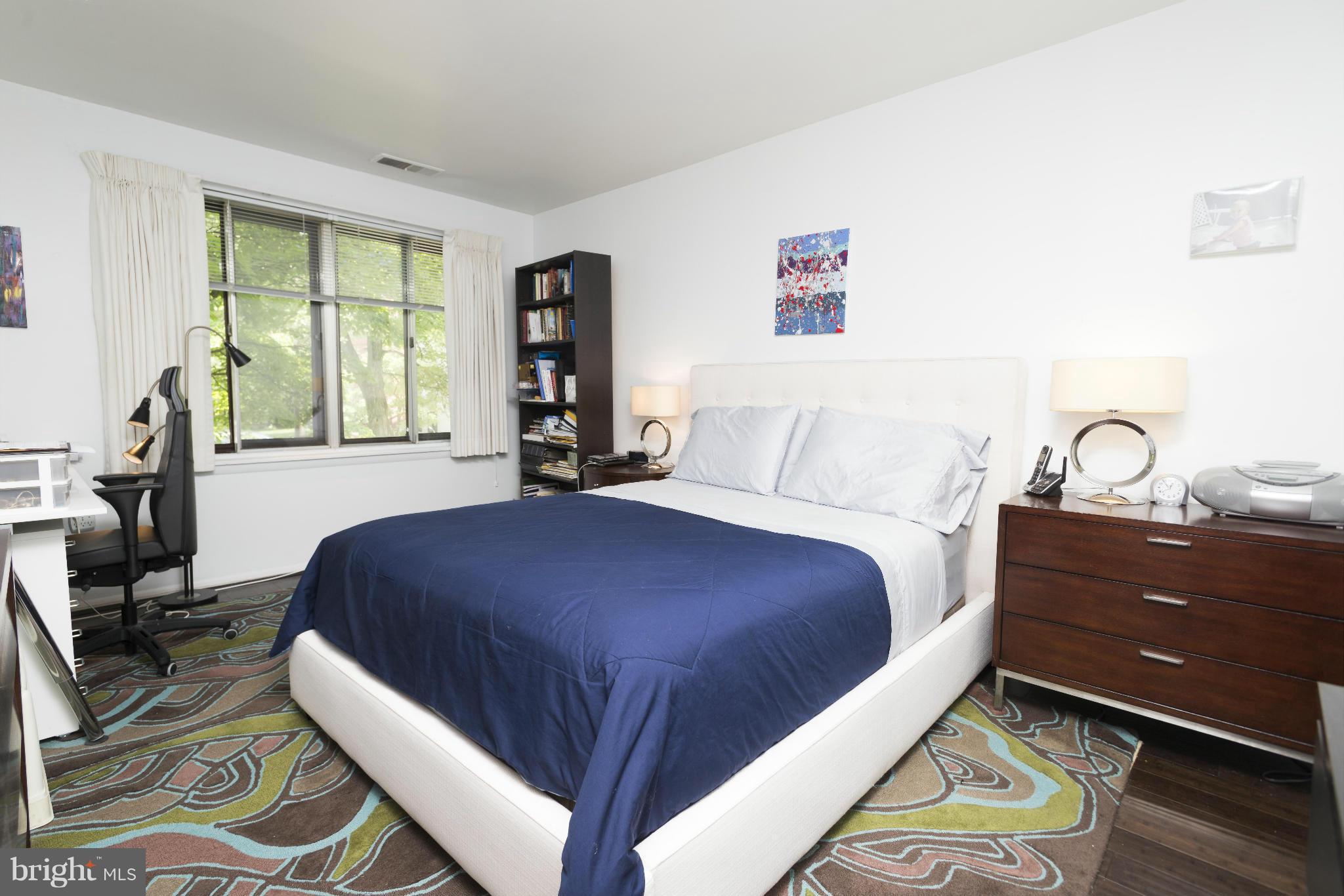 5 Hamill Road, Unit 5C Baltimore, MD 21210 - Photo 14 of 24 a bedroom with a bed and a large window