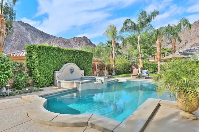 a view of a lake with a garden and swimming pool