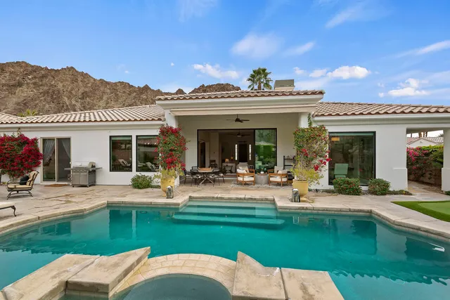 a view of a house with swimming pool and a garden