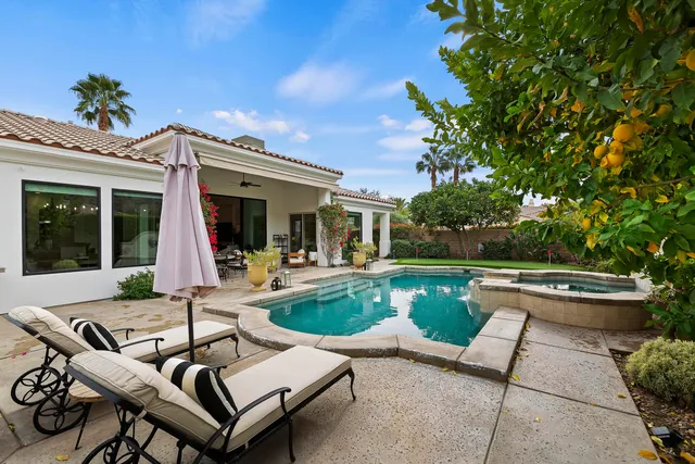 a view of a patio with couches table and chairs and potted plants