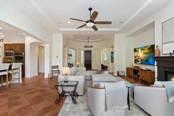 a living room with fireplace furniture and a flat screen tv