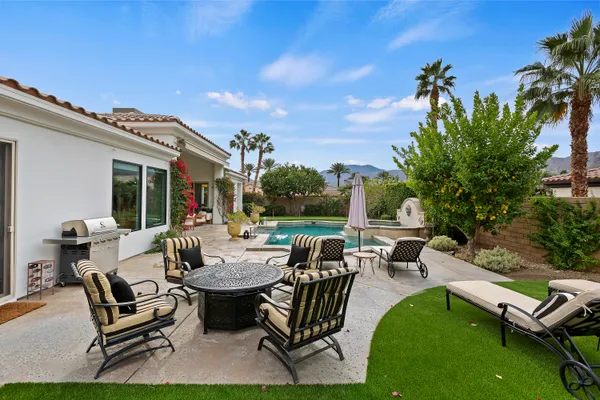 a view of a patio with chairs and a table and chairs