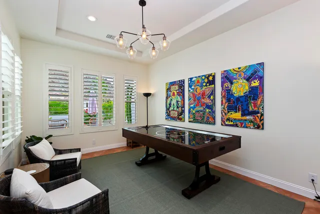 a living room with furniture a piano and a window