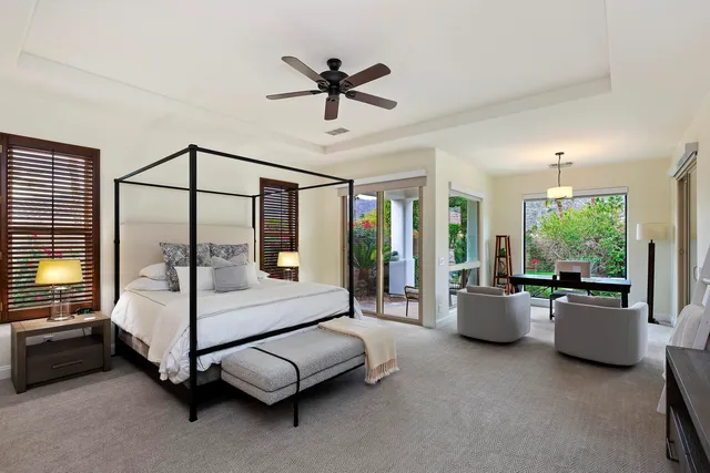 a living room with furniture ceiling fan and a window