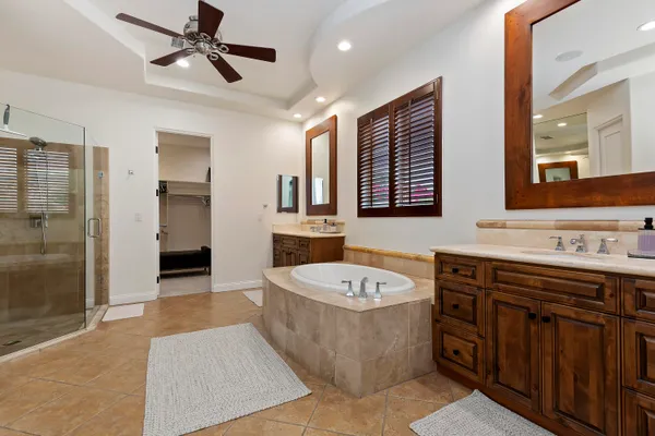 a bathroom with a tub a sink and a mirror
