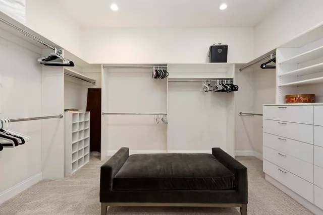 a living room with a bed and a ceiling fan