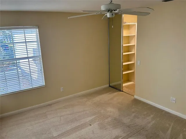 an empty room with windows and closet