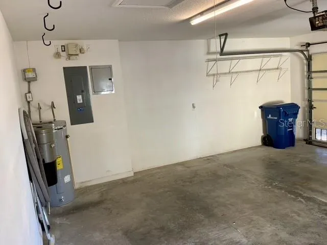 a patio with a table and chairs under an umbrella