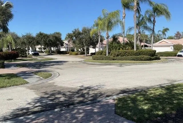 a front view of a house with a yard and fountain in middle