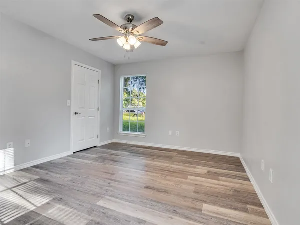 an aerial view of residential houses with outdoor space and trees