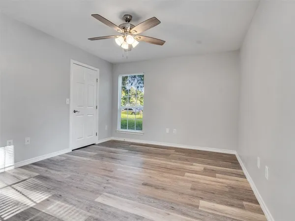 an aerial view of residential houses with outdoor space and trees