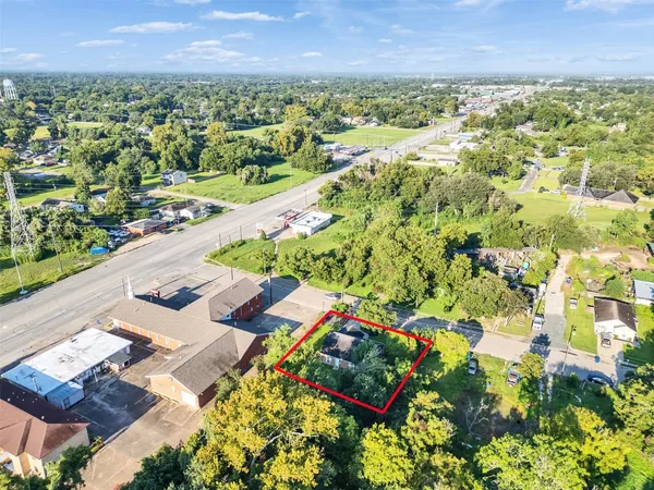 a house with green field in front of it
