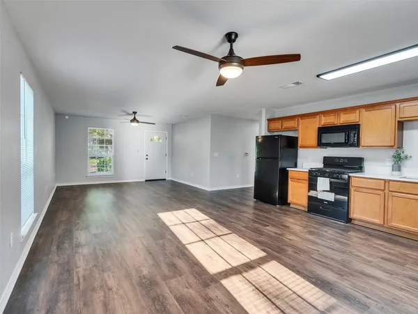 a view of kitchen with sink and wooden floor