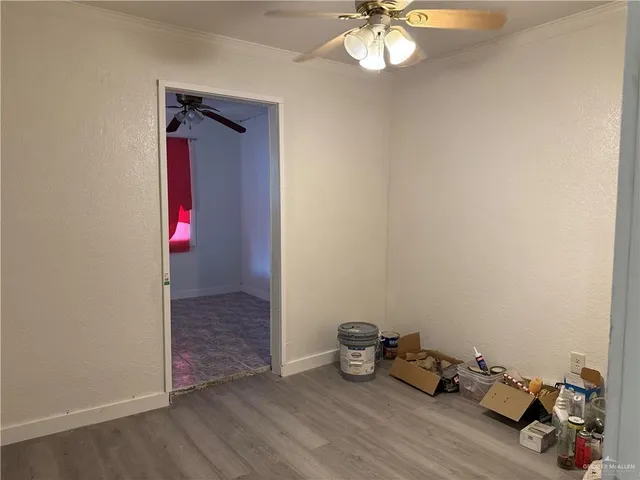 a view of a hallway with a chandelier fan