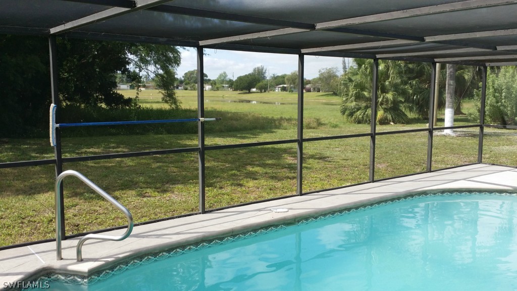 102 Jasmine Road West Lehigh Acres, FL 33936 - Photo 4 of 12 a view of swimming pool from a balcony