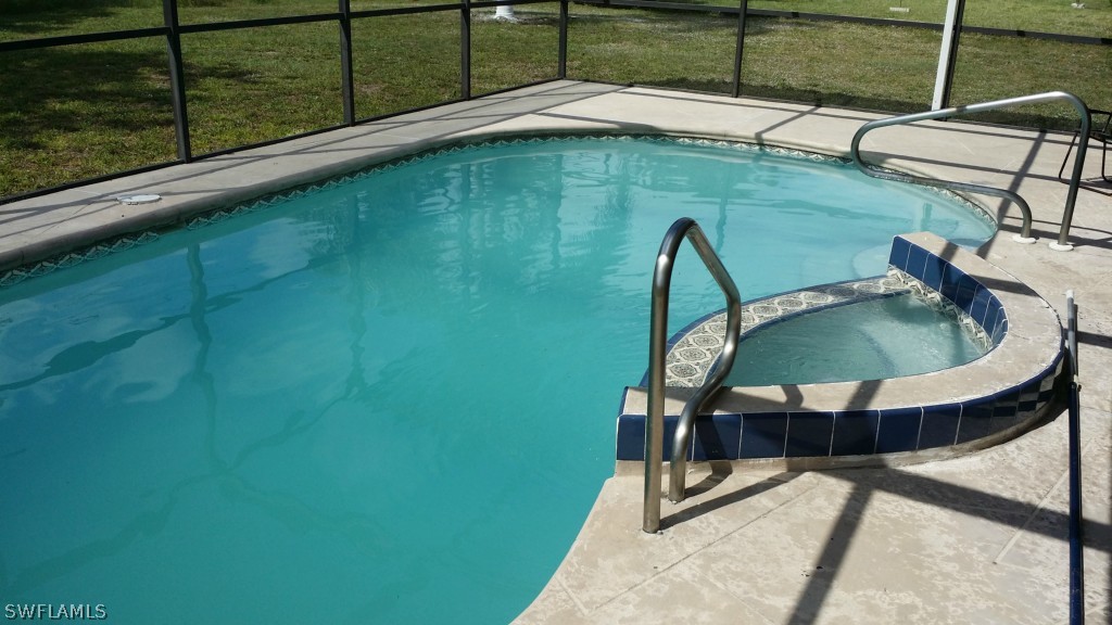 102 Jasmine Road West Lehigh Acres, FL 33936 - Photo 6 of 12 a table and chairs sitting in a backyard