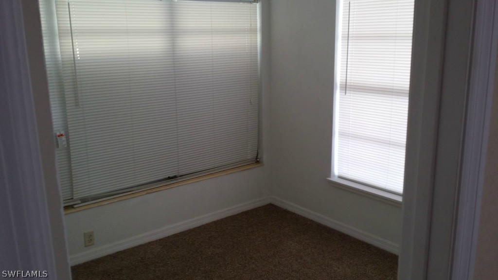 102 Jasmine Road West Lehigh Acres, FL 33936 - Photo 9 of 12 a view of a small space with wooden floor and a window