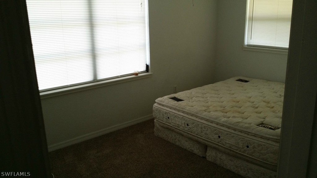 102 Jasmine Road West Lehigh Acres, FL 33936 - Photo 10 of 12 a room with a bed and a window