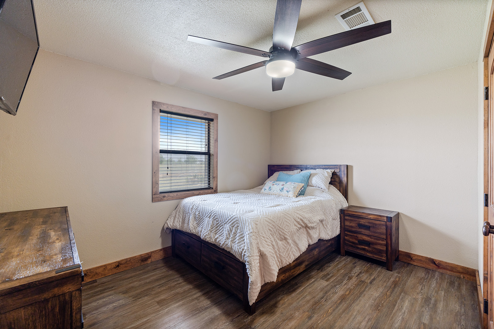 1001 Gravel Pit Road Taylor, TX 76574 - Photo 14 of 38 Bedroom with dark wood-type flooring, ceiling fan, and a textured ceiling
