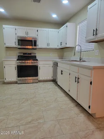a kitchen with stainless steel appliances granite countertop a sink and a stove
