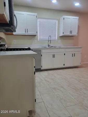 a kitchen with stainless steel appliances granite countertop a sink a stove and a granite counter tops