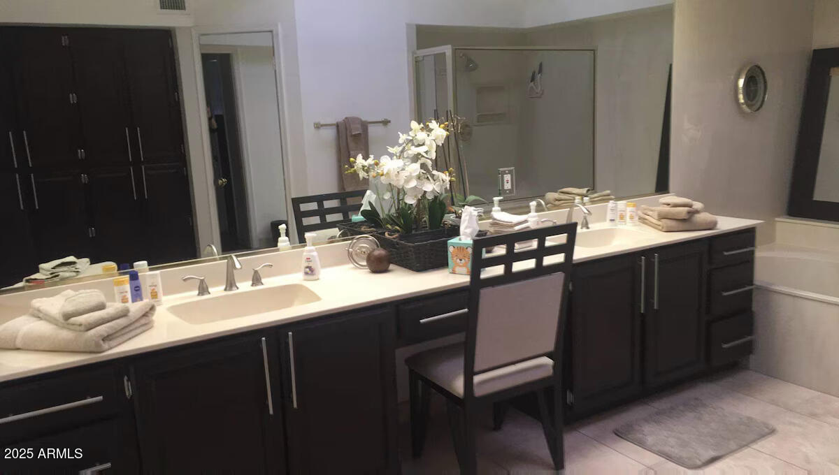 10413 North 45th Place Phoenix, AZ 85028 - Photo 10 of 25 a bathroom with a double vanity sink and a mirror