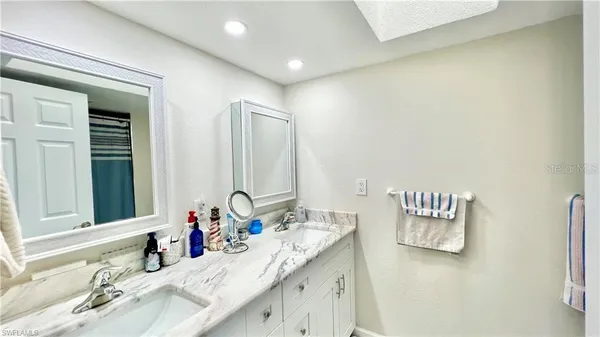 a bathroom with a double vanity sink and a mirror