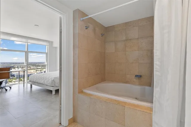 a en suite bathroom with a bathtub and next to a window