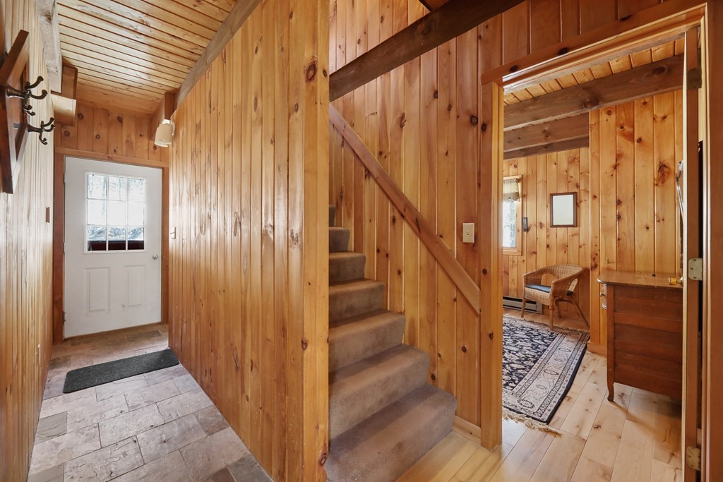 49 Judd Road Otis, MA 01253 - Photo 3 of 42 a view of a hallway with wooden floor and staircase