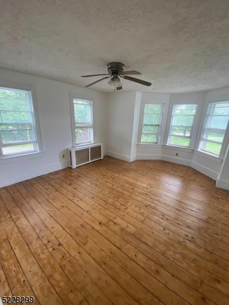 9 Dock Road Denville, NJ 07866 - Photo 11 of 21 an empty room with wooden floor and windows