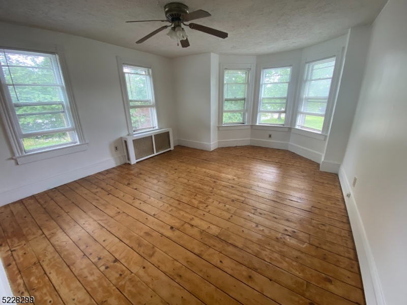 9 Dock Road Denville, NJ 07866 - Photo 12 of 21 wooden floor in an empty room with a window